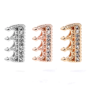 Three crown charms in silver, gold, and rose gold with sparkling rhinestone details