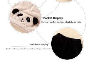 Detail of plush children's panda pajamas showing embroidered pocket and elastic waistband