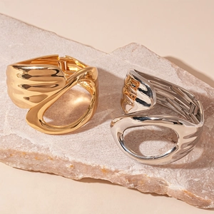 Abstract geometric hollow open cuff bracelet in polished gold and silver metal finishes