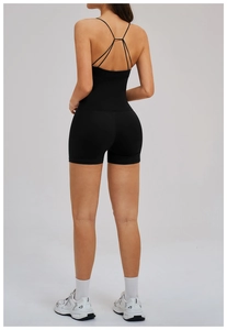 Detail of cross-back yoga top and matching high-waist shorts in matte black finish