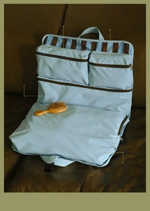 Detail view of light blue travel organizer bag featuring multiple zipper compartments