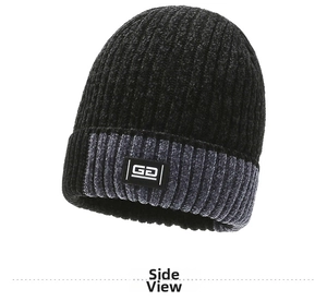 Detail of knit beanie showing two-tone black and grey ribbed texture with logo patch