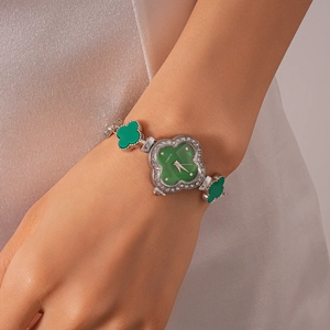 Close-up of green clover quartz watch featuring sparkling rhinestones on the bezel