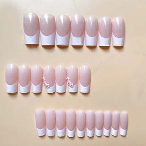 French tip press-on nails with 3D pink flowers and gold beads on pink base