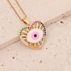 Close-up of golden heart pendant with rainbow gemstones and evil eye enamel design