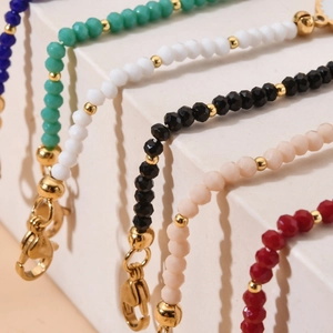Detailed view of faceted crystal bead bracelets in six colors with gold lobster clasps