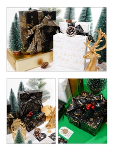 Detail of black and gold Christmas wrapping paper with festive snowflakes and foil texture