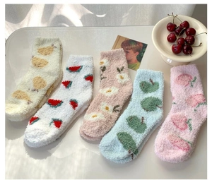 Detailed flat lay of soft coral fleece socks with colorful fruit and flower embroidery
