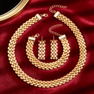 Golden watchband chain jewelry set with necklace, bracelet and earrings on red silk