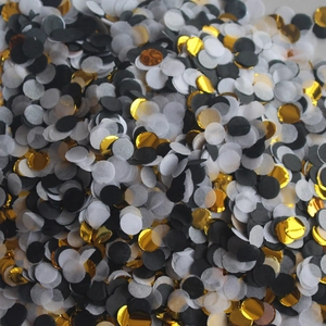 Macro shot of black white and gold foil push-pop confetti for wedding party decorations