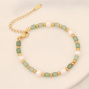 Detailed close-up of natural stone pearl bracelet with golden beads and extension chain