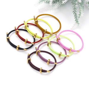Detailed view of colorful woven cord bracelets with adjustable gold metal bead clasps
