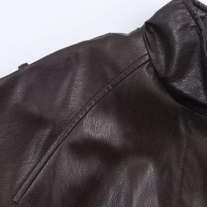Detail of dark brown faux leather jacket showing premium texture and shoulder stitching