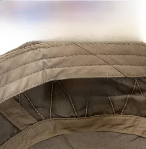 Detail of 100% cotton washed military cap showing internal care label and quality stitching