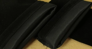 Close-up of black velvet jewelry pouch texture with durable stitched fabric details