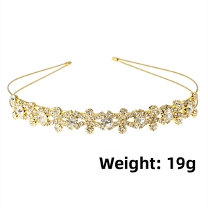 Detailed view of elegant gold thin headband featuring dense rhinestones and pearls decoration