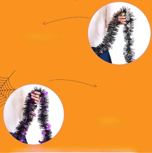 Detail of Halloween tinsel garland with silver skulls and purple bats for party decor