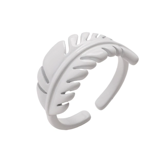 Detailed view of white leaf-shaped lacquer ring with adjustable open band design