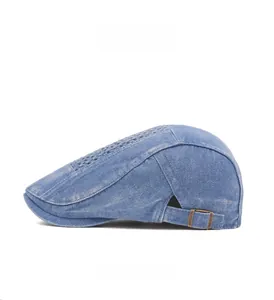 Side view of washed denim flat cap featuring adjustable metal buckle and breathable holes