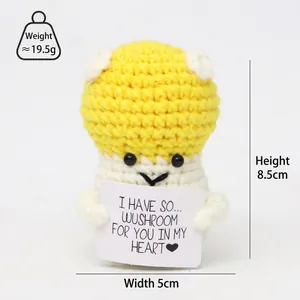 Macro view of handmade crochet mushroom doll showing detailed yarn texture and card
