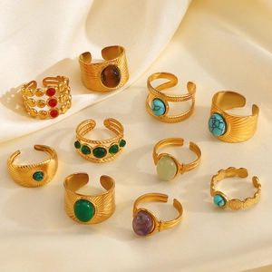 Vintage 18k gold plated stainless steel rings with colorful gemstones on beige silk fabric