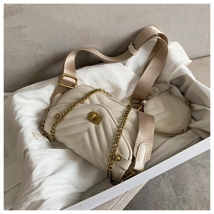 Detailed unboxing of a cream quilted crossbody bag with a round coin purse and metal chain