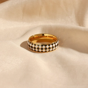 18K gold plated stainless steel ring with black and white checkered enamel pattern on silk