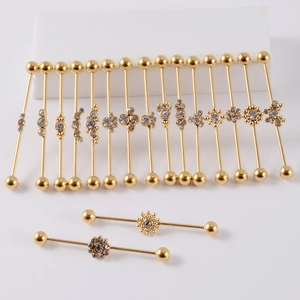 Set of 14 golden stainless steel industrial barbells with flower crystal decorations