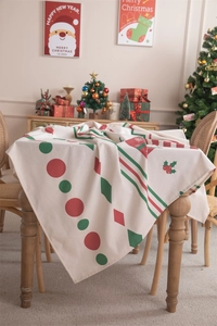 Close-up of Christmas tablecloth with red and green festive geometric patterns on wood table