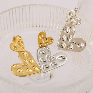 18K gold plated stainless steel heart earrings with hammered texture in glass bowl