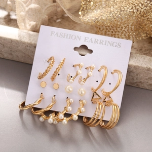 Detail view of nine-piece golden alloy earring set with faux pearls on display card