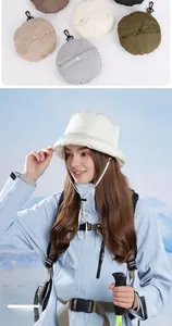 Detail showing foldable padded bucket hat with portable hook and windproof rope for winter
