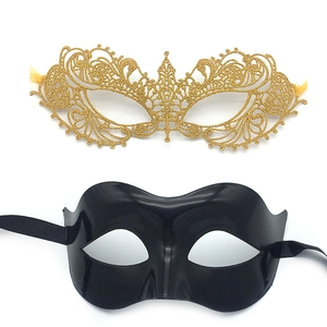 Detail of gold hollow lace and smooth black half-face masquerade masks with ribbons
