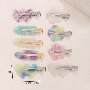 Detailed view of floral and heart hair clips set showing 5.5cm x 3cm size and weight
