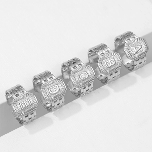 Detail of silver letter rings A-E with watchband style bands and crystal inlay