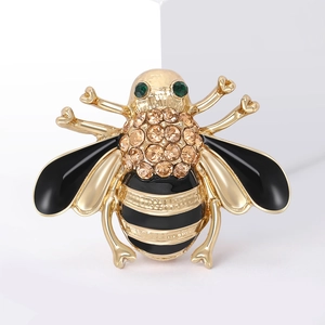 Chic bee brooch in gold metal with black enamel wings and sparkling yellow rhinestones