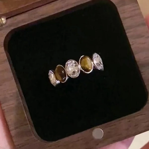 Tiger eye and zircon open ring in silver setting displayed inside a wooden jewelry box