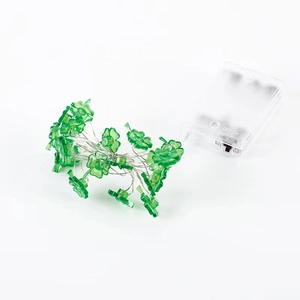 Detail of green four-leaf clover LED fairy lights with clear plastic battery box cover