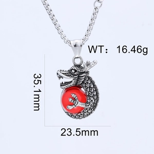 Close-up of vintage silver dragon pendant with central red bead and detailed sizing info