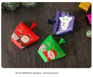 Three Christmas gift boxes with Santa and reindeer motifs featuring ribbon tie closures