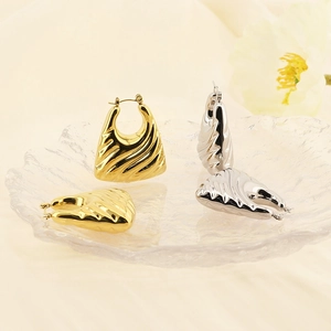 Geometric 18k gold and silver titanium steel hoop earrings with textured finish