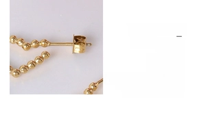 Macro detail of 18k gold plated beaded earrings with secure pin back and textured finish