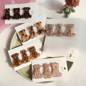 Cute cartoon bear rabbit dog hair clips set in diverse colors on a green ceramic plate