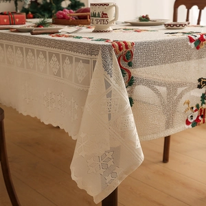 Detailed embroidery and lace openwork on a vintage beige Christmas tablecloth