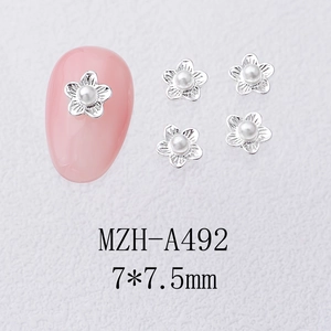 Detail of camellia nail art charms with silver flower petals and pearl centers, 7x7.5mm