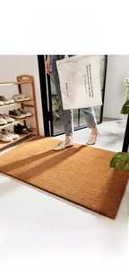 Close-up of natural coir fiber texture and non-slip backing on a durable entrance mat