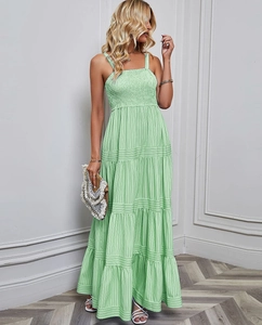 Detail of smocked elastic bodice and thin straps on a tiered striped summer dress
