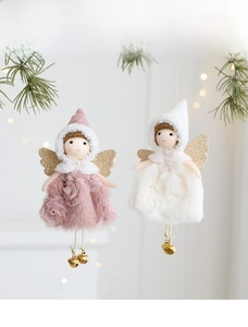 Macro view of plush Christmas angel ornaments with embroidered rose patterns and gold bells