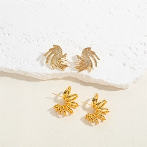 Textured gold-plated fan-shaped earrings and multi-layered circular studs set on stone