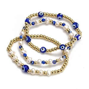 Detailed view of three-piece set featuring golden beads and blue evil eye charms